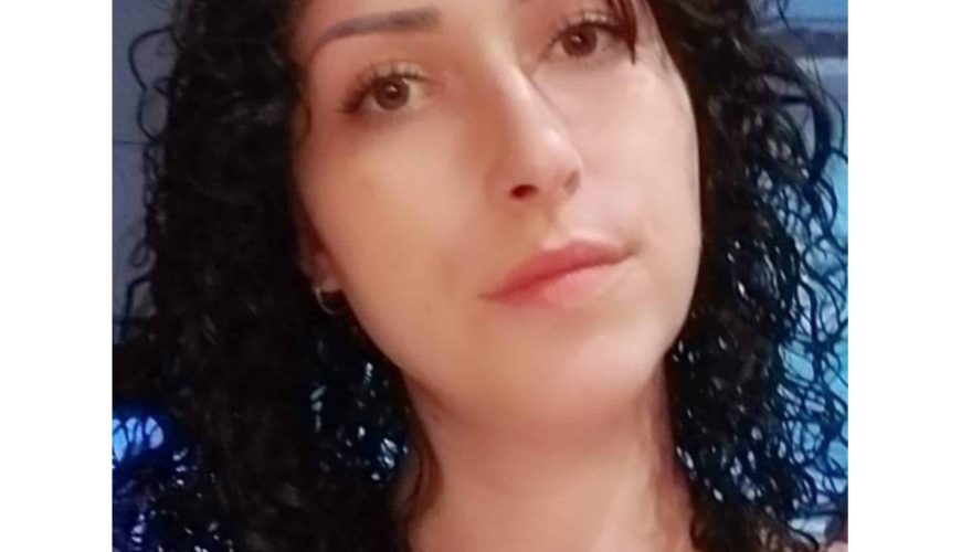 A woman with curly dark hair and light skin looks into the camera with a neutral expression. The background is softly lit. The word "METROPOLIS" appears below the image.
